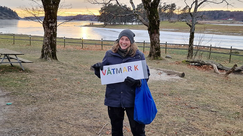 Naturveileder som holder plakat med teksten VÅTMARK